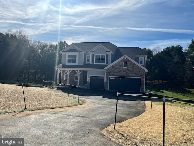 view of front facade with a porch and a garage