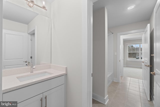 bathroom with tile patterned floors, vanity, and bathing tub / shower combination