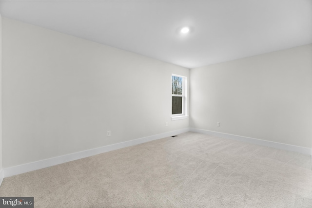 unfurnished room with light carpet