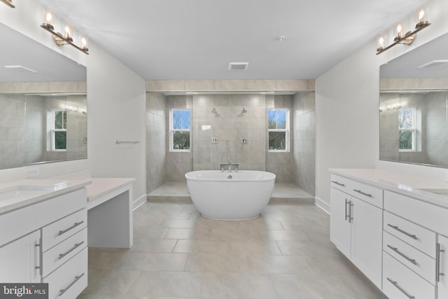 bathroom with shower with separate bathtub, vanity, and tile patterned floors