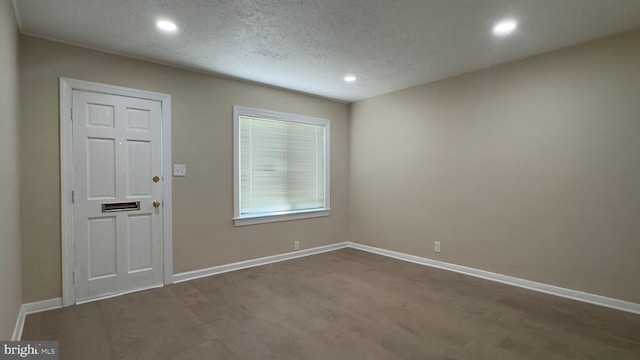 foyer entrance with a textured ceiling and hardwood / wood-style flooring