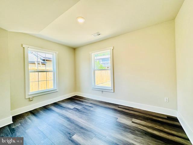 spare room featuring dark hardwood / wood-style floors