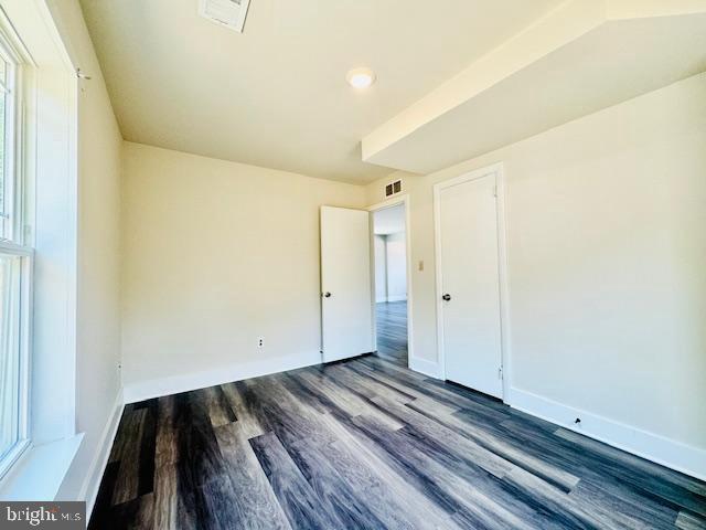 empty room featuring dark hardwood / wood-style floors