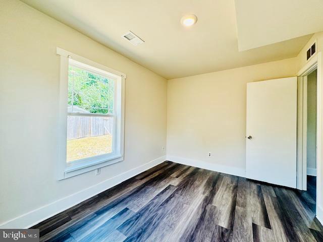 unfurnished room featuring dark hardwood / wood-style floors