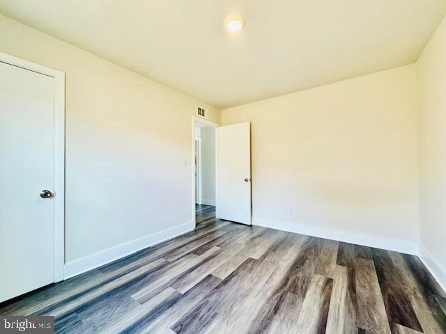 spare room with wood-type flooring