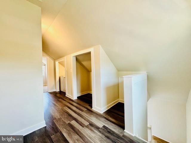 bonus room featuring dark hardwood / wood-style floors and lofted ceiling