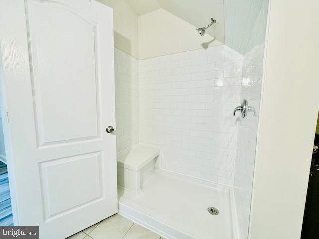 bathroom with a shower and tile patterned floors