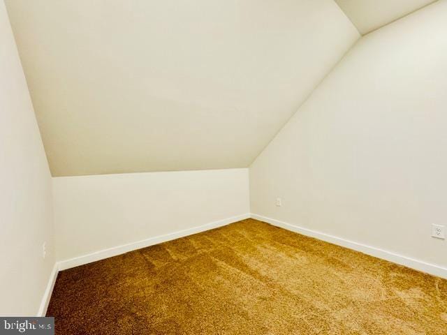 bonus room with lofted ceiling and carpet floors