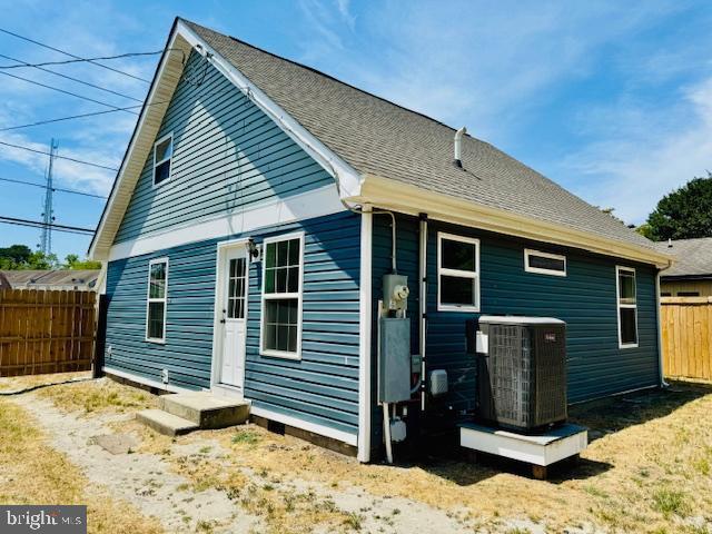 back of property featuring central AC