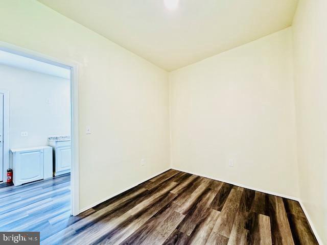 empty room featuring dark wood-type flooring