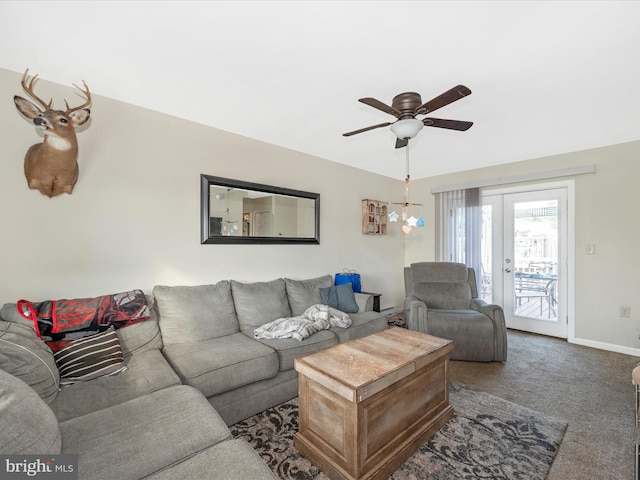 carpeted living room with french doors and ceiling fan with notable chandelier