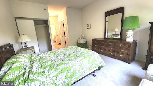 bedroom with light carpet and a closet