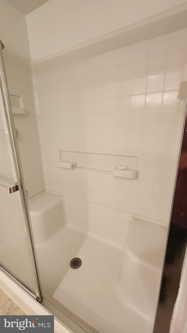 bathroom with a shower with shower door