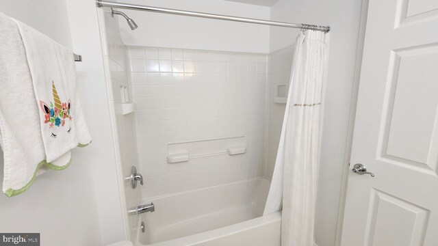 bathroom with shower / bath combo with shower curtain