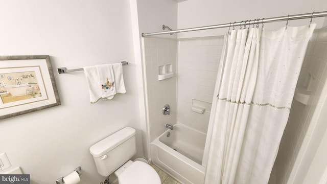 bathroom featuring shower / tub combo and toilet