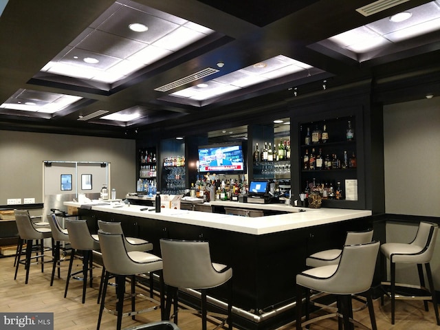 bar with hardwood / wood-style floors, coffered ceiling, and beam ceiling