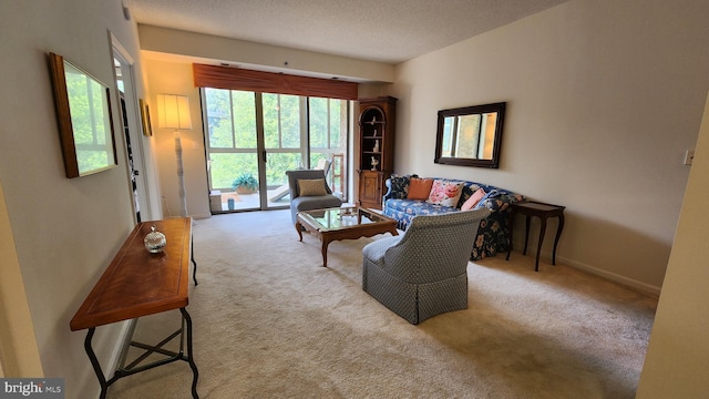 carpeted living room featuring a textured ceiling