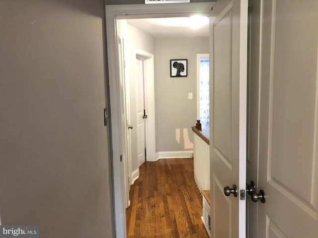 hallway with dark hardwood / wood-style flooring