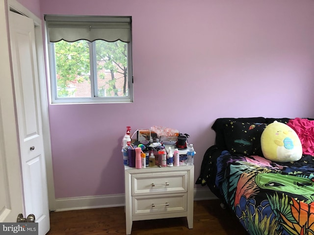 bedroom with dark hardwood / wood-style flooring