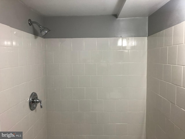 bathroom with tiled shower