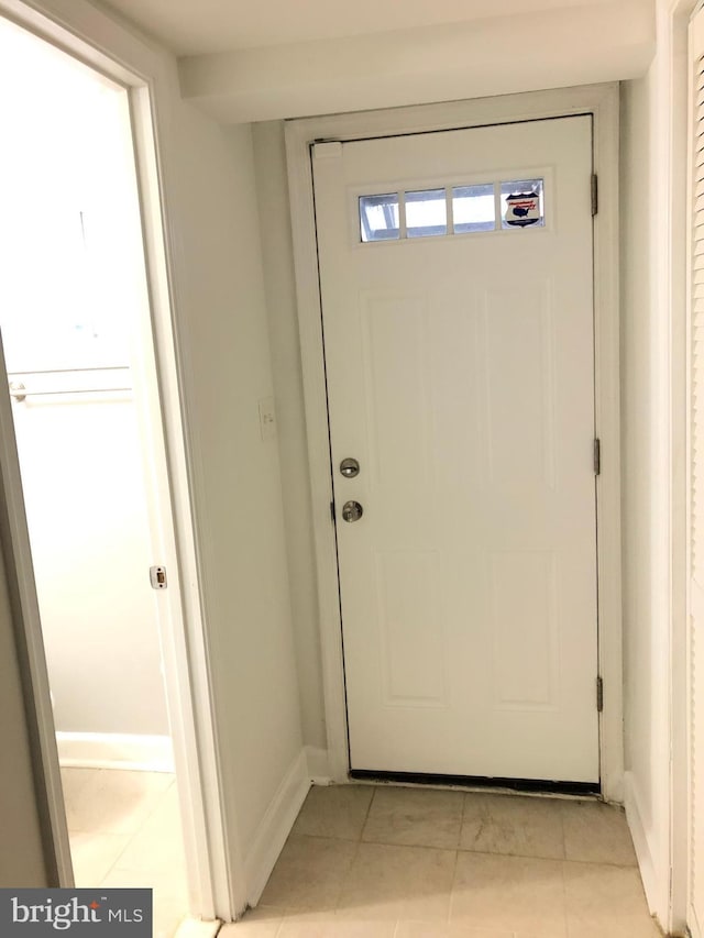 doorway to outside featuring light tile patterned floors