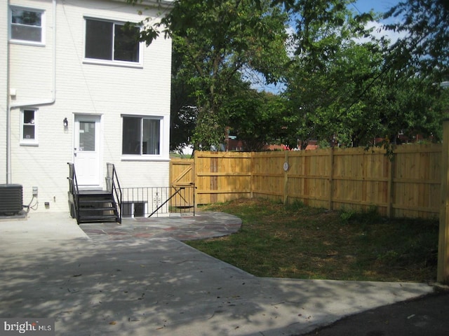 back of property with a patio and central AC unit