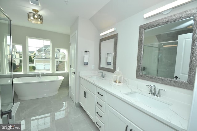 bathroom featuring vanity and shower with separate bathtub