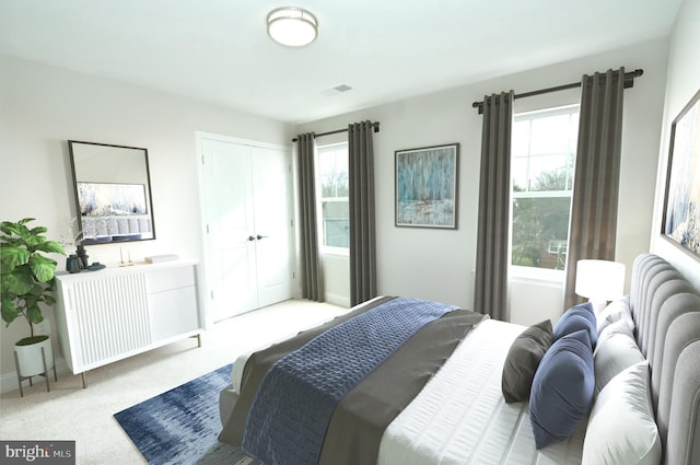 bedroom featuring light carpet and multiple windows