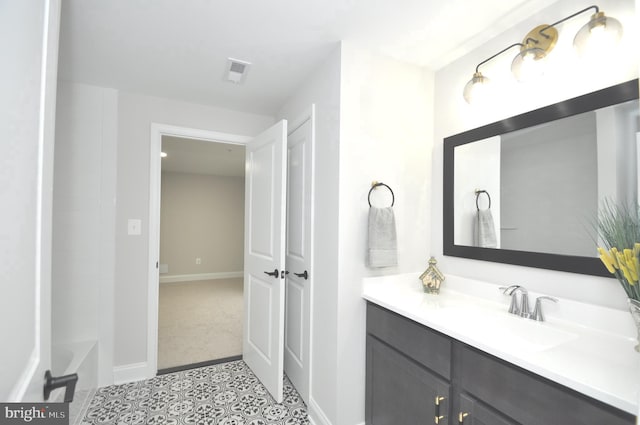 bathroom featuring tile patterned flooring, vanity, and a bath