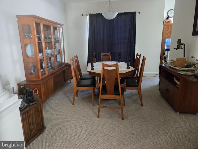 dining area with light colored carpet