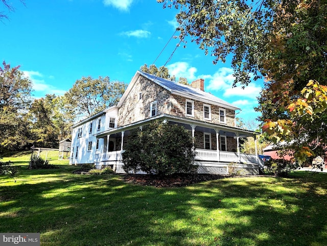 exterior space featuring a front lawn and covered porch