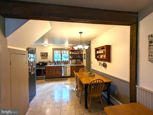 dining space featuring an inviting chandelier, sink, beam ceiling, and baseboard heating