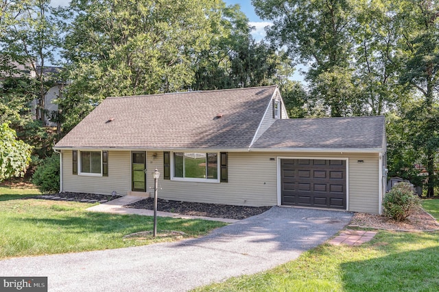 view of front facade featuring a garage and a front lawn