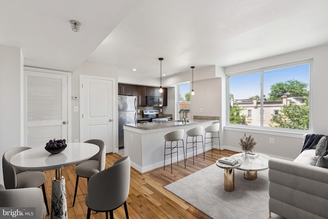 living room with light hardwood / wood-style flooring and sink