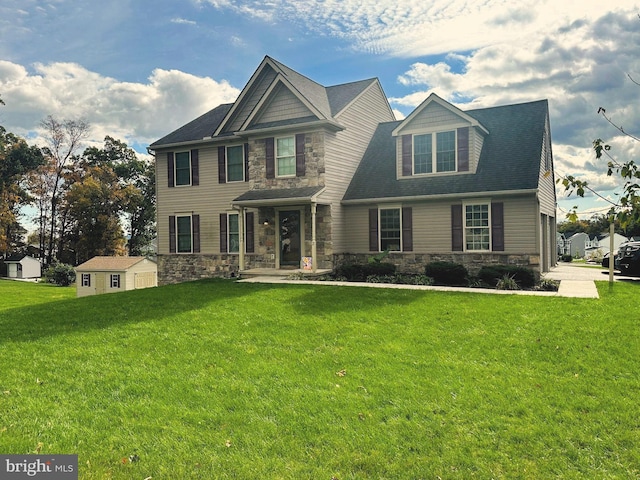 view of front of property featuring a front lawn and a storage unit