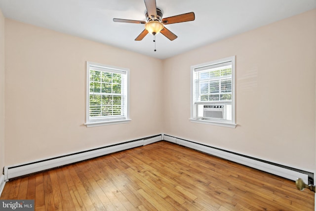 unfurnished room with plenty of natural light, cooling unit, a baseboard heating unit, and light hardwood / wood-style flooring