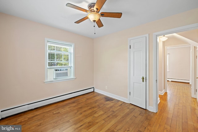 empty room with ceiling fan, light hardwood / wood-style floors, and baseboard heating