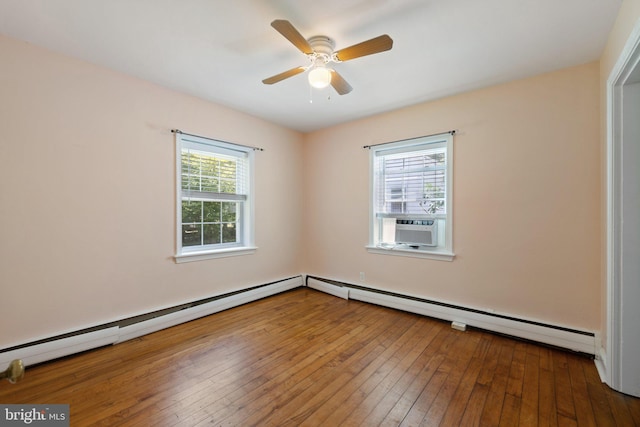 empty room featuring hardwood / wood-style floors, ceiling fan, and cooling unit