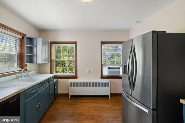 kitchen featuring stainless steel refrigerator with ice dispenser, a wealth of natural light, radiator, sink, and dishwasher