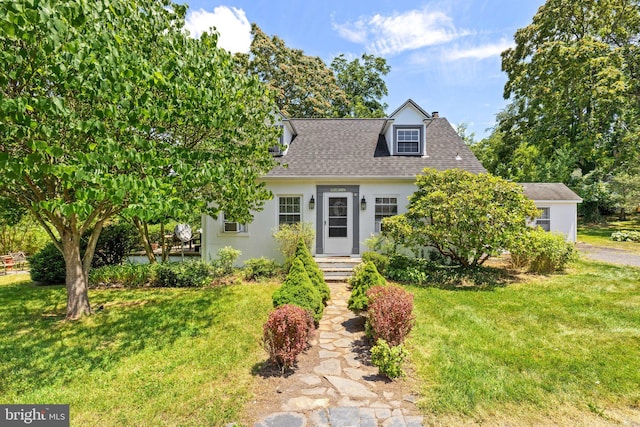 new england style home with a front lawn