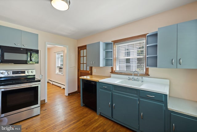 kitchen featuring sink, baseboard heating, a healthy amount of sunlight, and black appliances