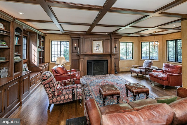 living room with beamed ceiling, coffered ceiling, an inviting chandelier, and dark hardwood / wood-style floors