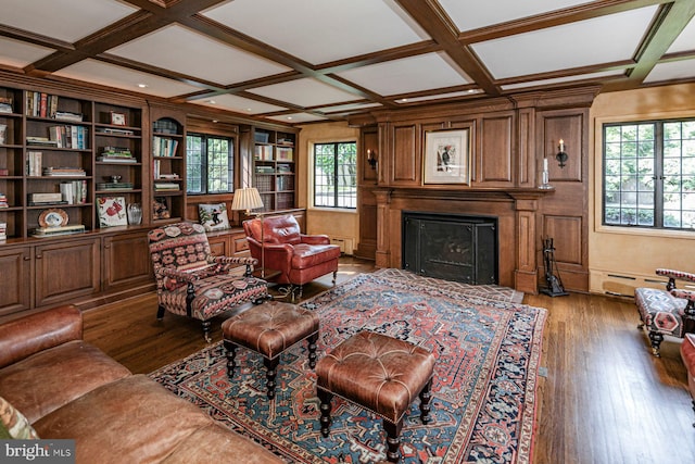 living room with coffered ceiling, a wealth of natural light, dark hardwood / wood-style floors, and baseboard heating