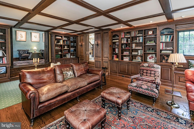 living room featuring built in shelves, beamed ceiling, coffered ceiling, and dark hardwood / wood-style flooring