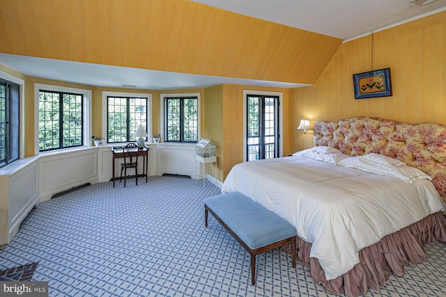 bedroom featuring lofted ceiling and multiple windows