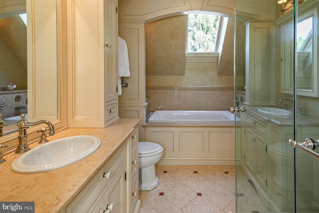 bathroom featuring a bathtub, tile patterned floors, toilet, and vanity