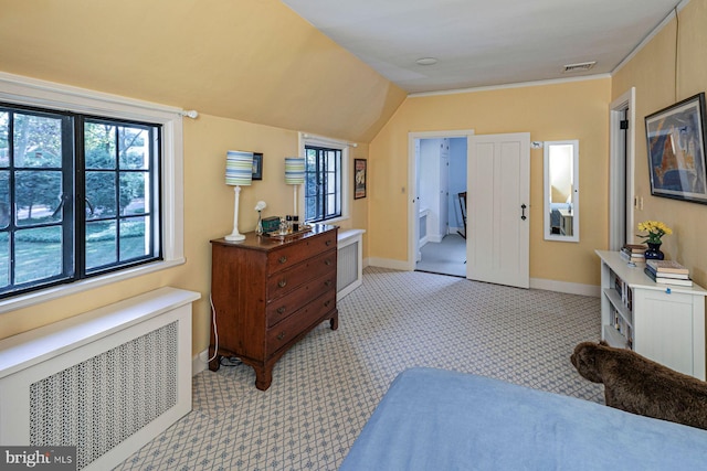 interior space with lofted ceiling, light colored carpet, connected bathroom, and radiator