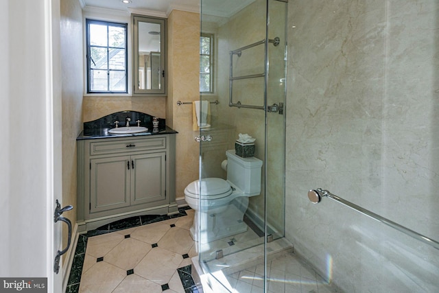 bathroom featuring vanity, crown molding, tile patterned flooring, a shower with shower door, and toilet