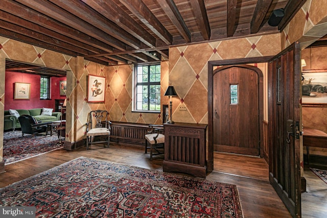 entrance foyer with wooden ceiling, dark hardwood / wood-style floors, beamed ceiling, and wooden walls