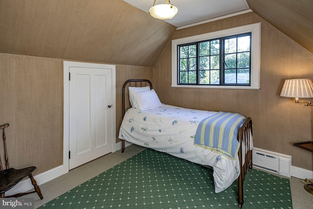 bedroom featuring carpet floors, a baseboard radiator, and vaulted ceiling